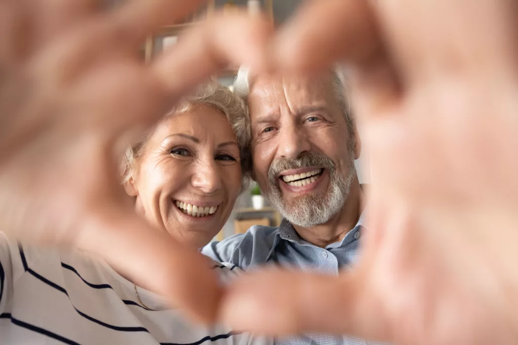 People looking through hand heart